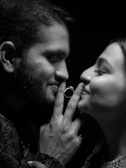 A playful and creative black and white shot focusing on the engagement ring. This unconventional pose is fun, intimate, and creates a memorable and unique portrait.