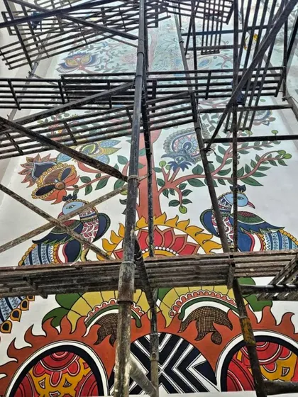 The base of the Kalamkari mural, where peacocks stand guard. This traditional Indian folk art style, usually seen on fabric, finds a new, permanent home on this wall.