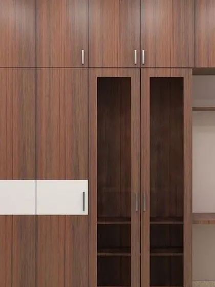 A practical wardrobe design that includes a built-in study desk and open shelving, perfect for a kid's room or a compact bedroom.