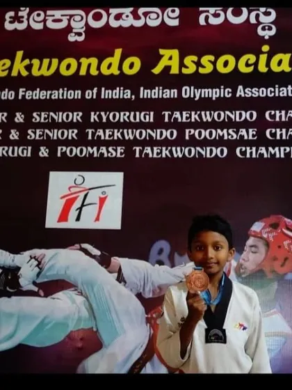 Even our youngest competitors bring home medals. This student shows his bronze medal from a state-level event, the start of a promising journey.