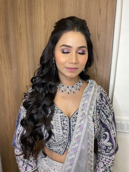 A close-up of the eye makeup. The purple and black smokey eye is dramatic yet sophisticated, perfect for an evening event.