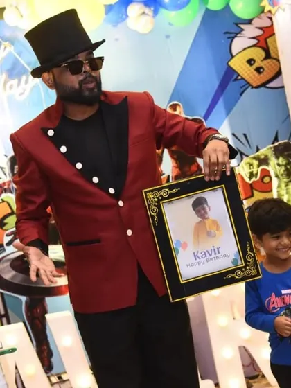 A proud moment for the birthday boy as I magically reveal a framed picture of him. This personalized trick is a wonderful surprise that makes the celebration even more special.
