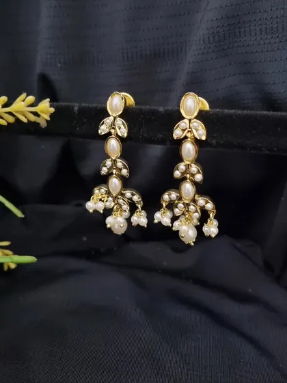 A close-up of the "Tara" earrings from the necklace set. They carry the same beautiful leaf and pearl design as the necklace, making them perfect to wear on their own as well.