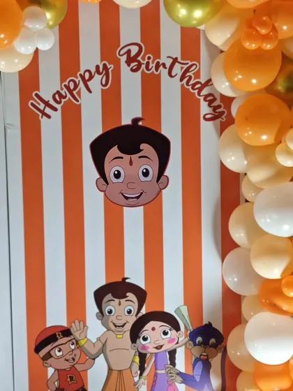 A close-up of the orange and white striped backdrop with Chota Bheem character's.