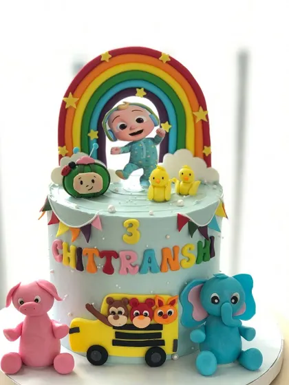 A vibrant Cocomelon cake that brings the nursery rhymes to life. It features JJ, the iconic watermelon, and other friends under a bright rainbow.