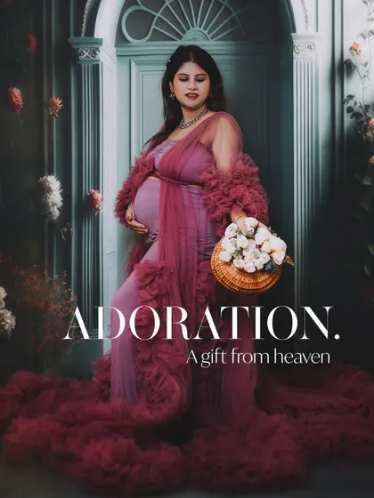 A solo portrait with the word "Adoration," capturing the feeling of reverence for the gift of life. The rich color of the gown and the floral backdrop are stunning.