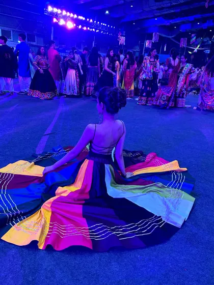 The beauty of a full-circle lehenga spread out on the dance floor. These moments make for fantastic photographs during any Garba or sangeet event.