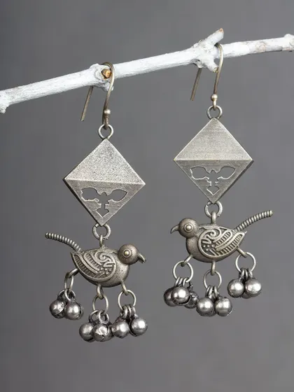 These charming oxidized silver earrings feature a bird motif with dangling ghungroos. They are playful, unique, and full of character.