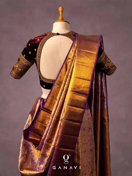 The elegant open-back design of the maroon velvet blouse, framed with detailed embroidery. This view showcases the beautiful contrast between the rich velvet and the lustrous silk of the saree.
