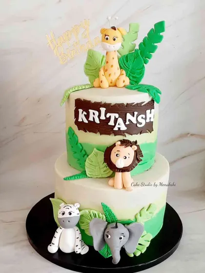 A very cute two-tier jungle themed cake for Kritansh. This design is similar to my other jungle cakes and features a giraffe, lion, tiger, and elephant, all handmade.