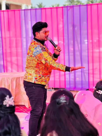 On the mic at a wedding carnival, guiding the guests through the various activities and games. My job is to be the ringmaster of your fun-filled celebration.