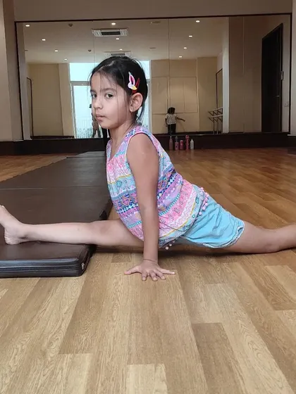 This young athlete is well on her way to achieving a full oversplit through consistent practice and stretching.
