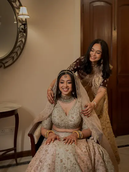 A mother's gentle touch. These are the moments that make a wedding day so special. The bride's soft glam makeup is perfect for these intimate memories.