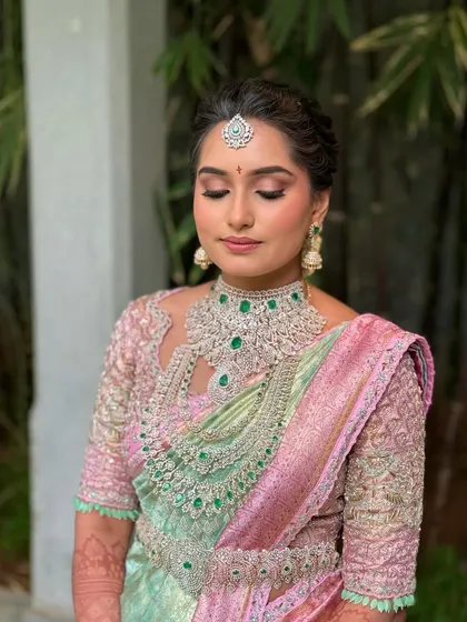 A serene portrait of Manasa. The makeup is designed to be lightweight and comfortable, allowing the bride to feel like herself.