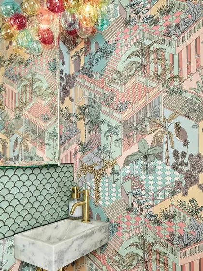 In a lively tribute to tropical grandeur, the radiant Miami wallpaper mesmerizes with its joyful tiers of terraced colonnades and luxuriant foliage, creating a kaleidoscope of tropical exuberance in this powder room.