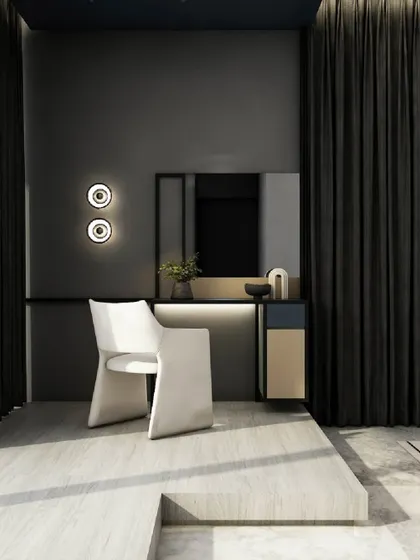 This bedroom corner showcases a monochromatic aesthetic with a sleek vanity setup. A sculptural white chair provides a strong focal point against the dark grey walls and heavy blackout curtains, creating a space of functional elegance.