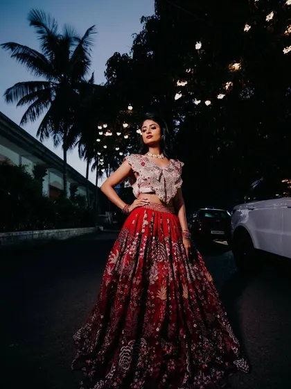 A dramatic, full-length shot. The lehenga and makeup create a powerful and beautiful silhouette.
