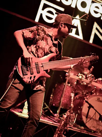 Another look at our talented bassist, completely in the zone during a performance at Fandom.