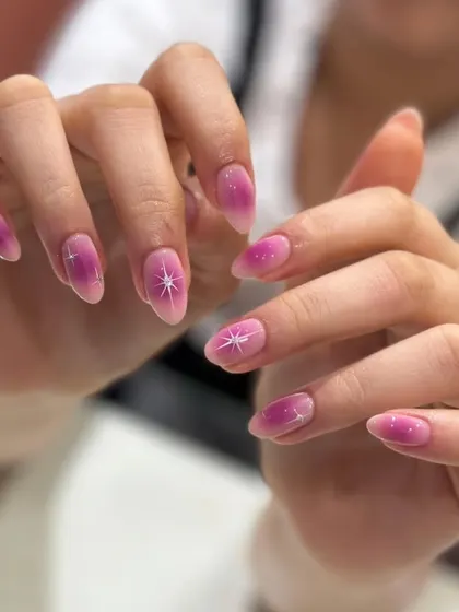 The full set of starry pink aura nails. This design is dreamy and magical, a popular choice for clients looking for something pretty and on-trend.