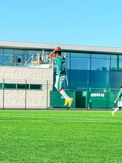 A player leaps in the air, practicing a throw-in during a training session on their international tour in London.