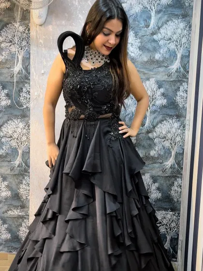 This unique black tiered gown is a showstopper for any evening event. I've paired it with a bold, modern choker to create a high-fashion look, all available for rent.