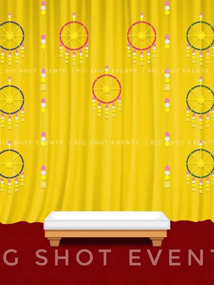This design concept for a Haldi ceremony features hanging dreamcatcher-style wheels against a yellow curtain. It's a modern twist on traditional decor, blending classic colors with contemporary elements.