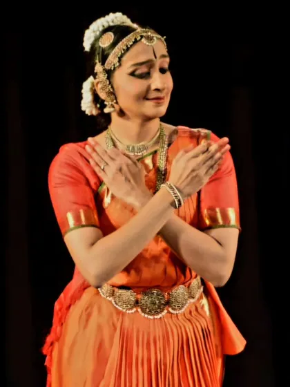 Ramya Suresh holding a pose of gentle offering, her performance a blend of strength and softness.