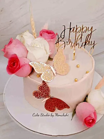 Flowers and butterflies adorn this pretty and delicious cake. Made with zero fondant, it features fresh roses and delicate butterflies for a classic, romantic look.