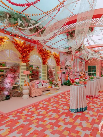 A wide view of the daytime event space, showing the patterned floor, draped ceiling, and distinct seating zones. This demonstrates how we structure a large space to feel both grand and intimate.
