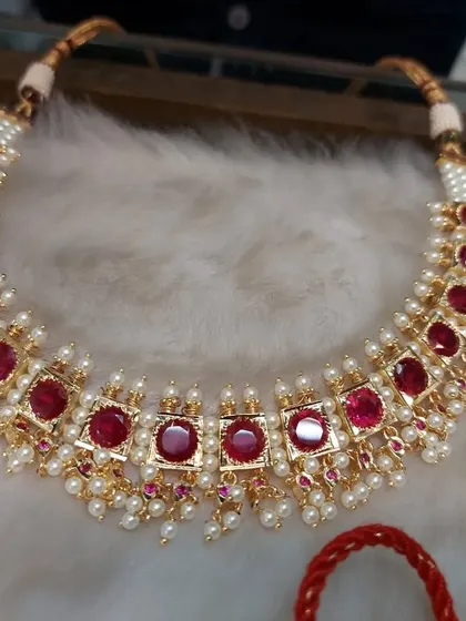 A classic ruby and pearl choker. This design is very popular for Maharashtrian weddings and adds a touch of color and elegance.