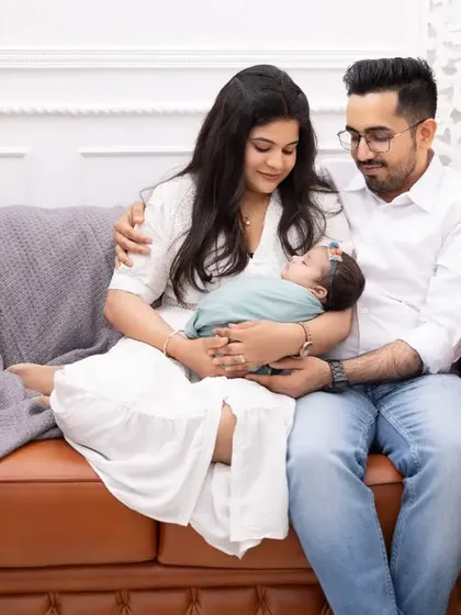 New parents admiring their sleeping baby. Our family photography sessions are designed to feel natural and unposed, allowing these beautiful, quiet interactions to unfold.