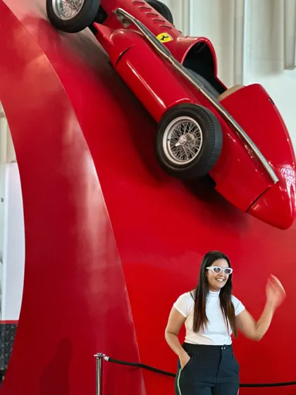 A fun, candid moment next to the iconic red race car display.