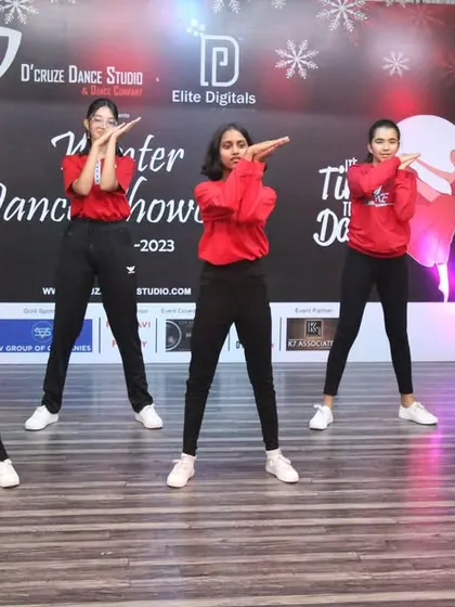 A group of our female students in matching red tops performing a synchronized routine for the Winter Showcase.