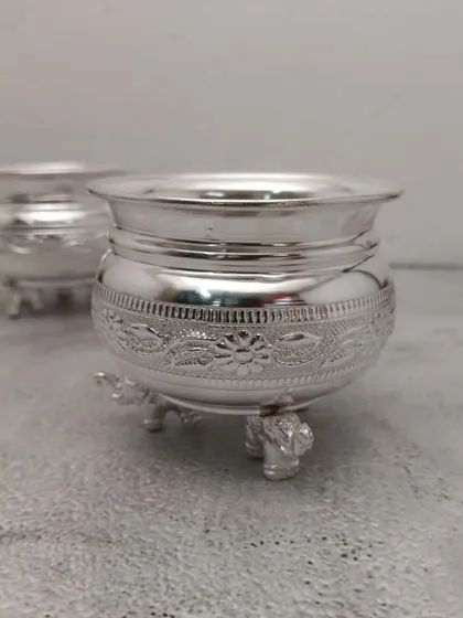 A close-up of the German silver elephant leg bowl, showing the detailed floral band around the middle.