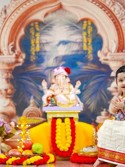 A sweet baby girl in a traditional parkar polka joins her hands in prayer, creating a heartwarming image of youthful devotion.