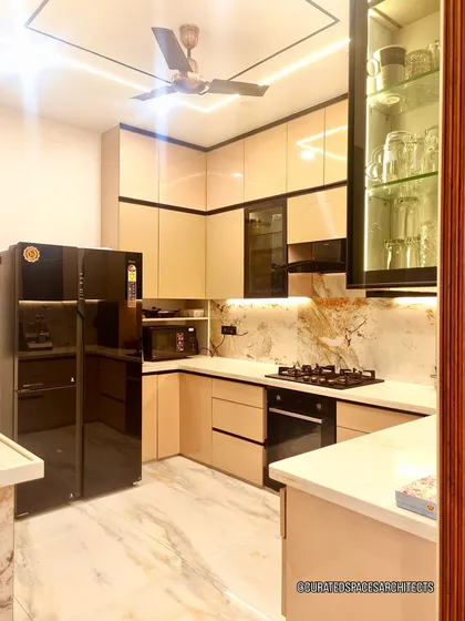A kitchen should be as beautiful as it is functional. For this open-plan kitchen renovation, I used sleek, high-gloss cabinetry, integrated appliances, and dramatic under-cabinet lighting to highlight the beautiful marble backsplash, creating a space that’s perfect for both cooking and socializing.