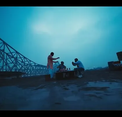 A beautiful wide shot of fans by the Howrah Bridge in the East Bengal FC ad. The scene captures the spirit of Kolkata and its love for football.