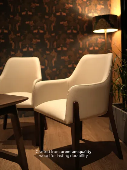 A pair of my custom dining armchairs, crafted from premium quality wood for lasting durability. Their versatile design makes them suitable for both dining and as accent seating.