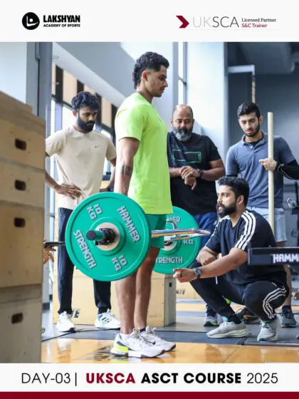 Peer-to-peer coaching during a deadlift session on Day 3. Participants learn to identify and correct common form errors in real-time.
