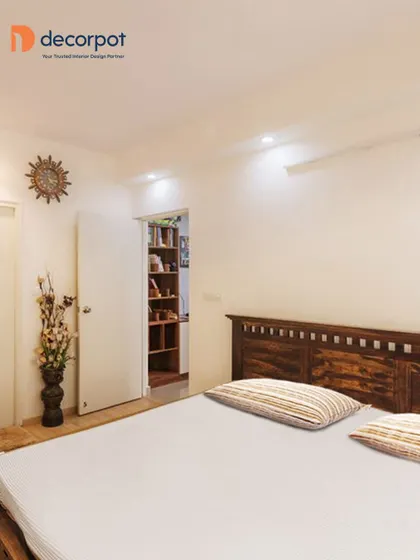 This bedroom shows a clever use of space with a hidden walk-in closet behind a simple door. It’s a great way to have extensive storage while maintaining a minimalist look in the main bedroom area.