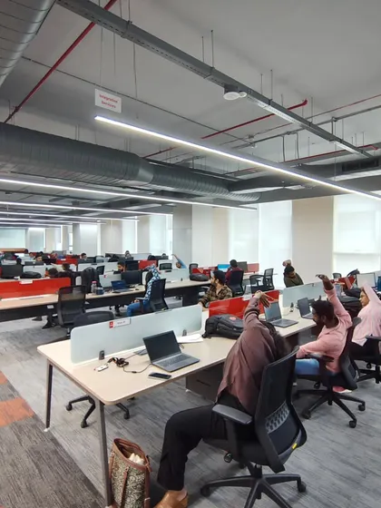 A wide shot of a desk yoga session in progress, demonstrating how an entire office floor can participate simultaneously.