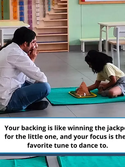A father sits on the floor with his child, exploring a Montessori material together. This partnership is key to a child's success.