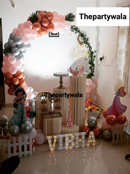 A beautiful princess theme with a rose gold and silver balloon arch, perfect for a sophisticated first birthday.
