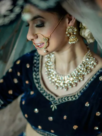 A close-up on the details of the makeup and jewelry, with a soft, dreamy filter.