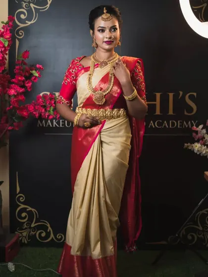 A full-length view of the classic red and cream muhurtham saree, a timeless choice for brides.