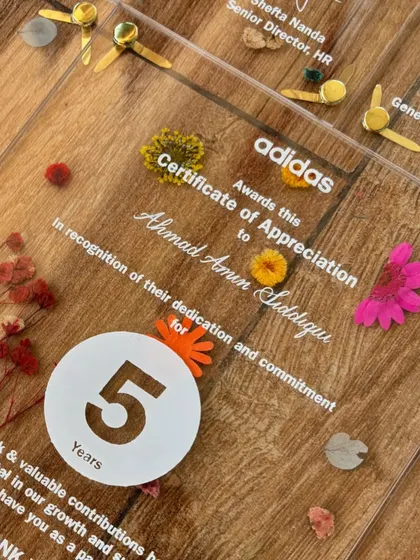 These acrylic certificates of appreciation for Adidas were a labor of love. Each piece features pressed flowers, screen-printed text, and custom calligraphy addressing to honor employees' years of dedication.