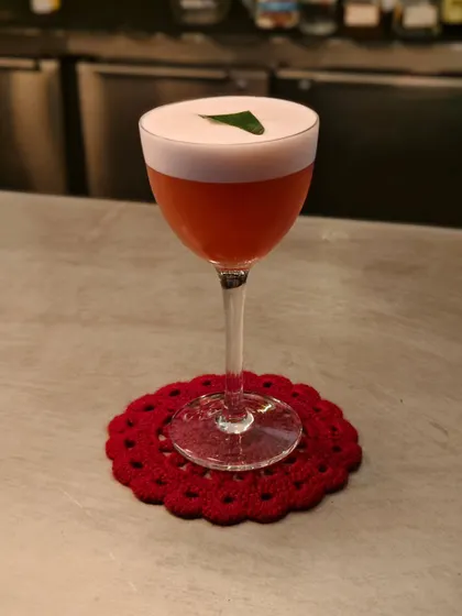 The Betel Leaf Sour Negroni. It's an adventurous drink with a hazelnut-infused gin and a frothy top, created especially for Negroni Week.