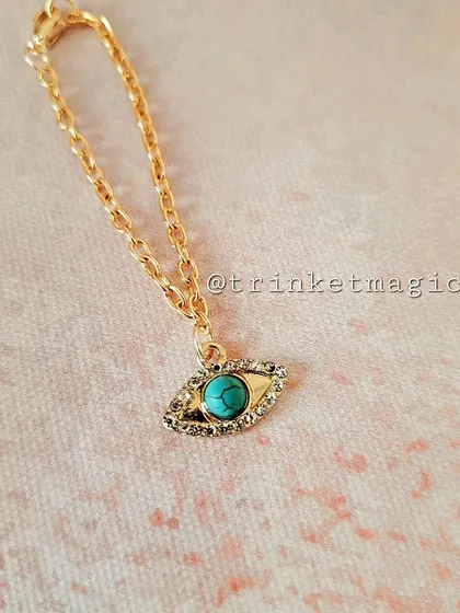 A hot-selling product, this turquoise evil eye watch charm is perfect for adding a pop of color and protection to your wrist.