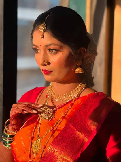 A classic, thoughtful pose that highlights the intricate details of her makeup and jewellery.