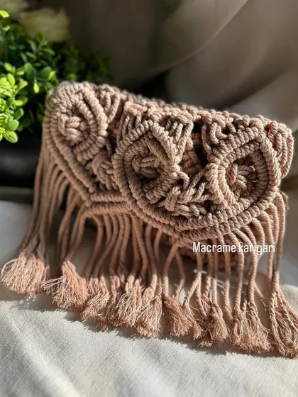 A close-up of the detailed knot work on our owl-themed macramé sling bag. The design features two large "eyes" and a fringed bottom, giving it a whimsical, bohemian feel.